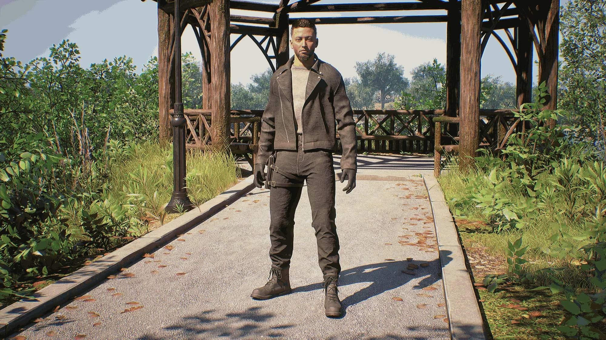 Detective Graham standing on a park path in front of a wooden gazebo